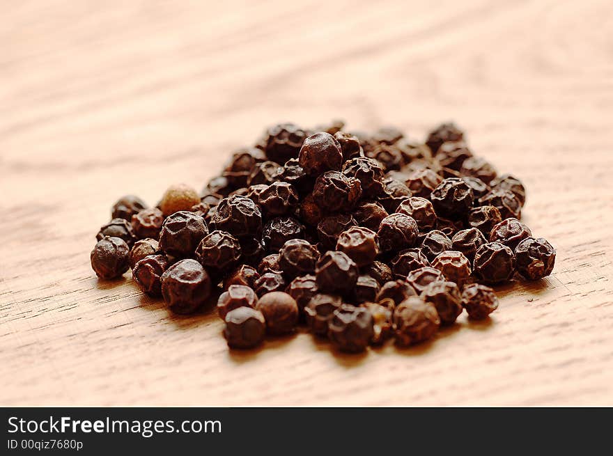 Black pepper on wood table