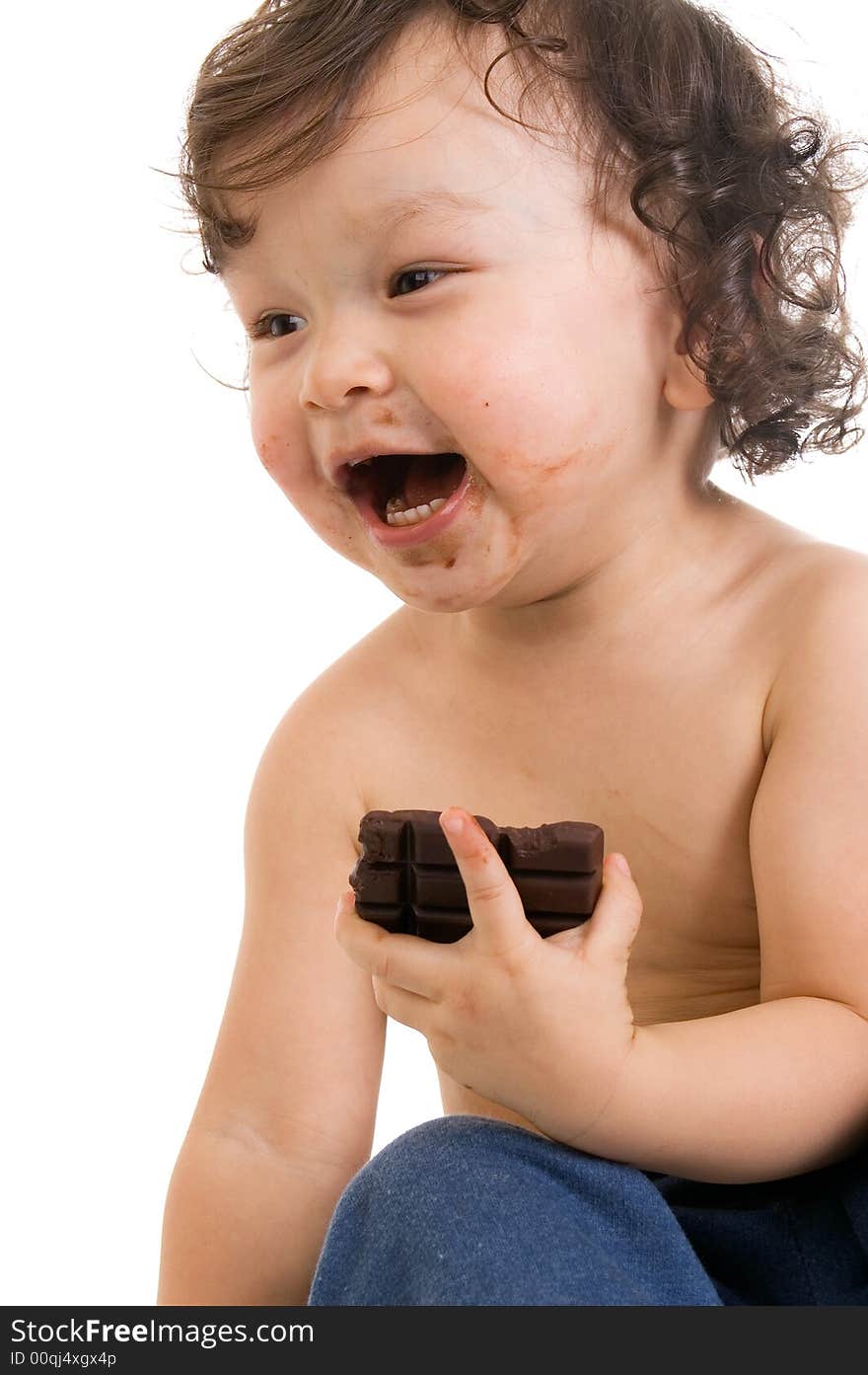 Child eats chocolate, isolated on a white background. Child eats chocolate, isolated on a white background.