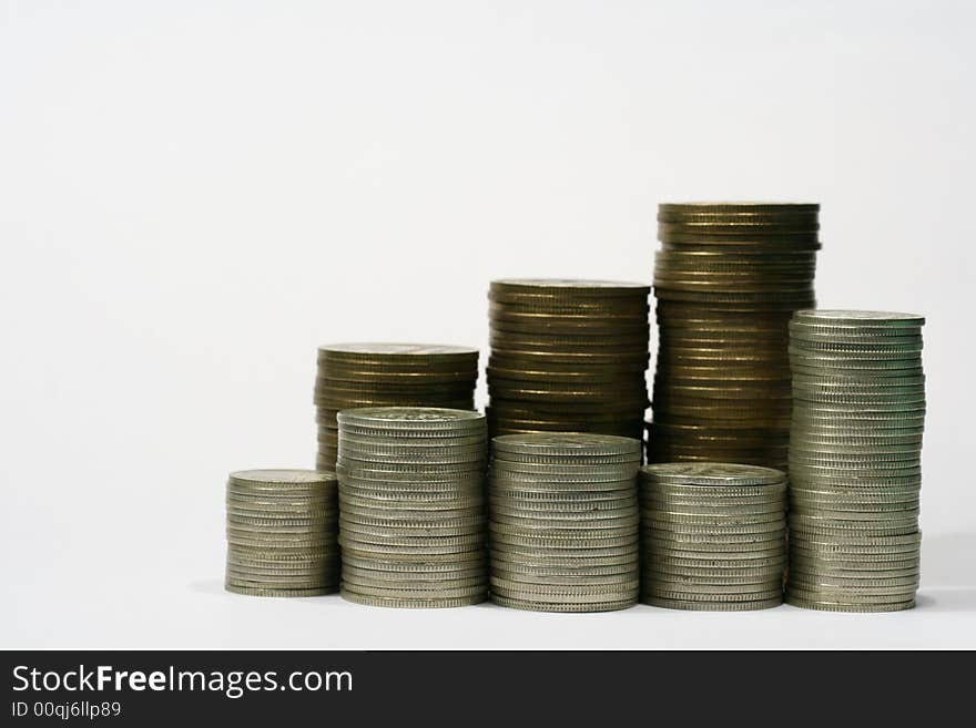 Close-up of multicolor coins stacks on the white background (isolated on white)