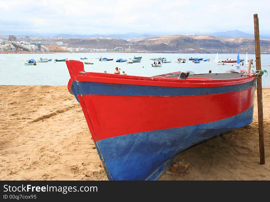 Blue and red fishing boat at the seashore. Blue and red fishing boat at the seashore