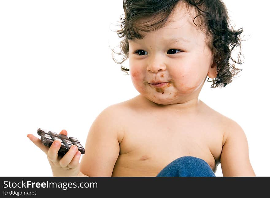 Child eats chocolate, isolated on a white background. Child eats chocolate, isolated on a white background.