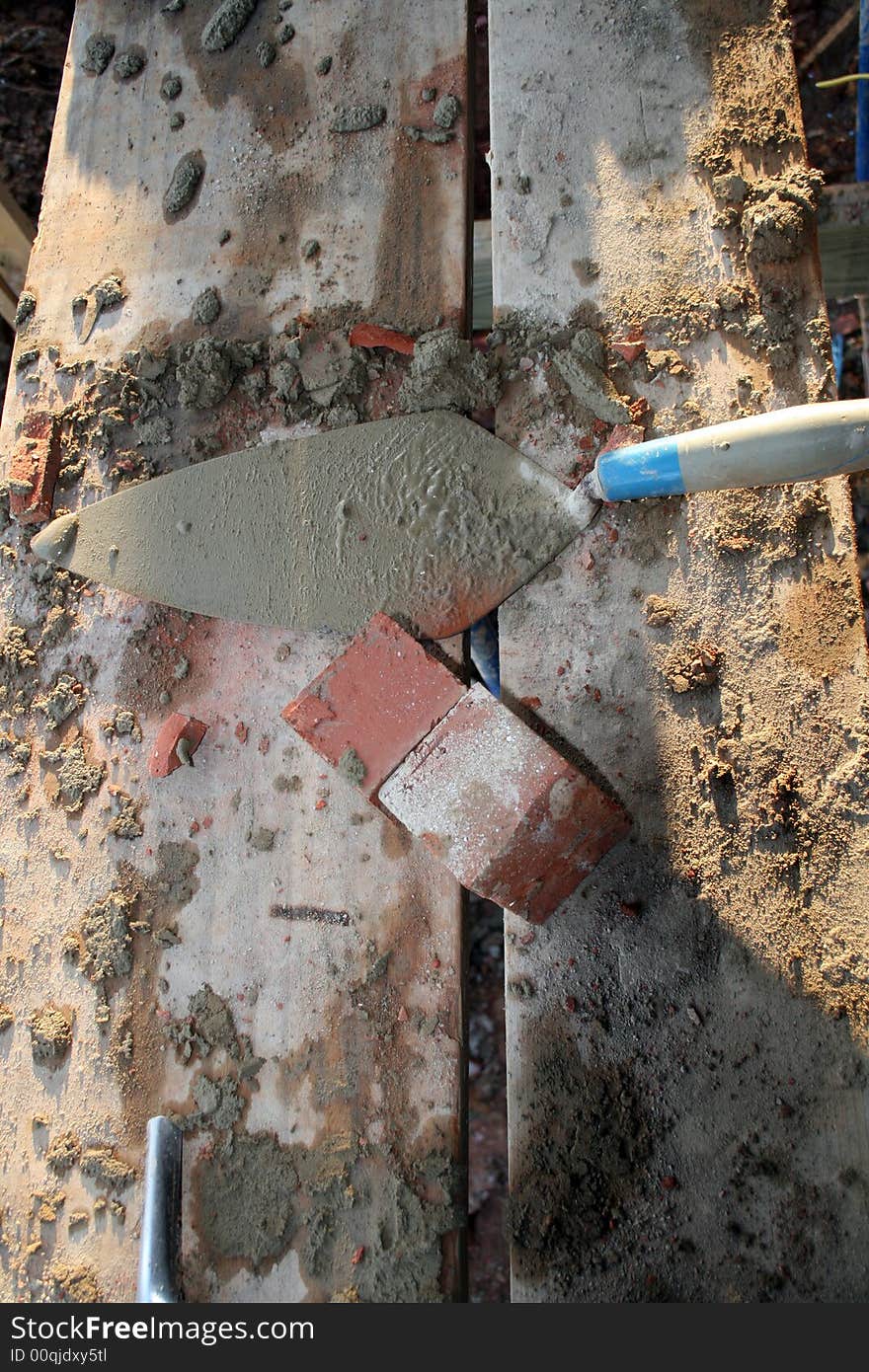 Trowel cement and brick at construction site. Trowel cement and brick at construction site