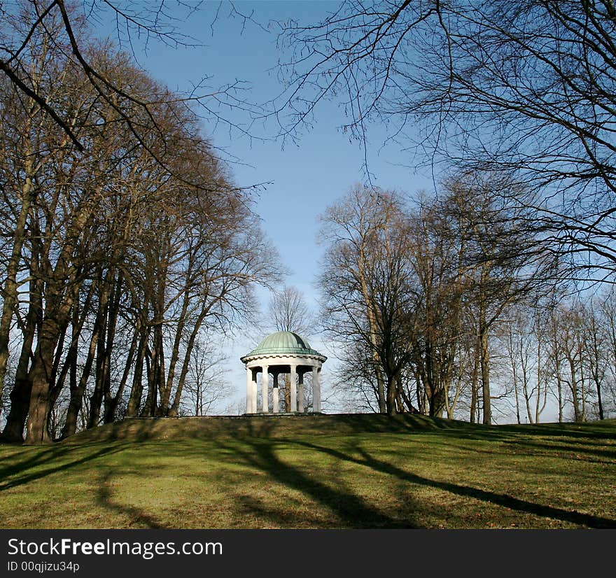 White round building in a garden. White round building in a garden