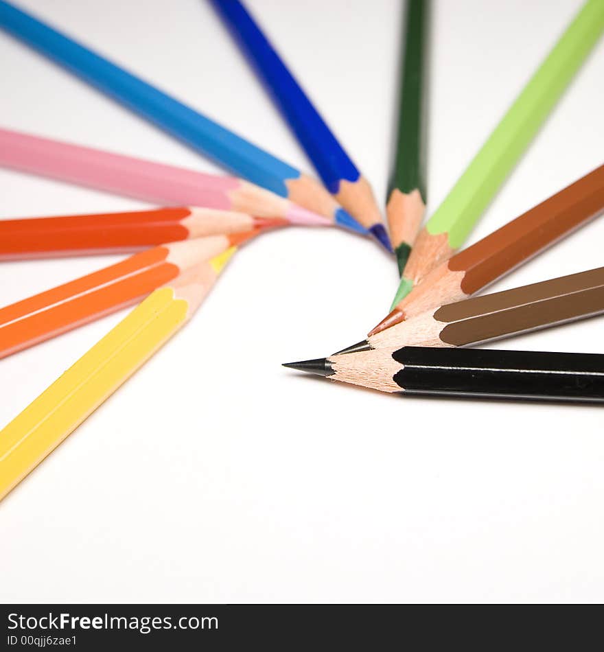 Colorful pencils isolated un white background, focus on black one. Colorful pencils isolated un white background, focus on black one