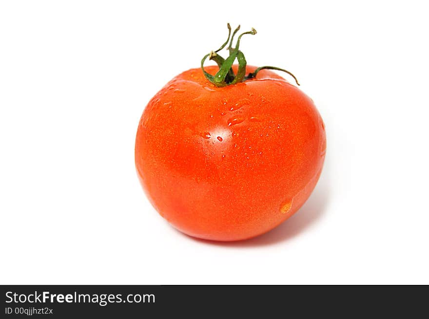 One red tomato with green ends isolated on white