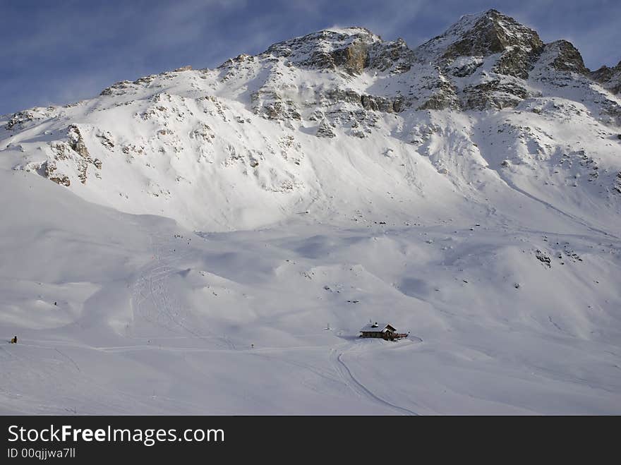 Alps house on a background  on a mountain. Alps house on a background  on a mountain