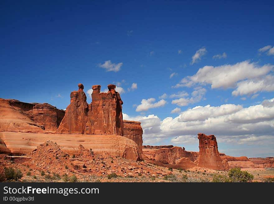 View of the red rock formations in Arches National Park with blue sky�s and clouds. View of the red rock formations in Arches National Park with blue sky�s and clouds