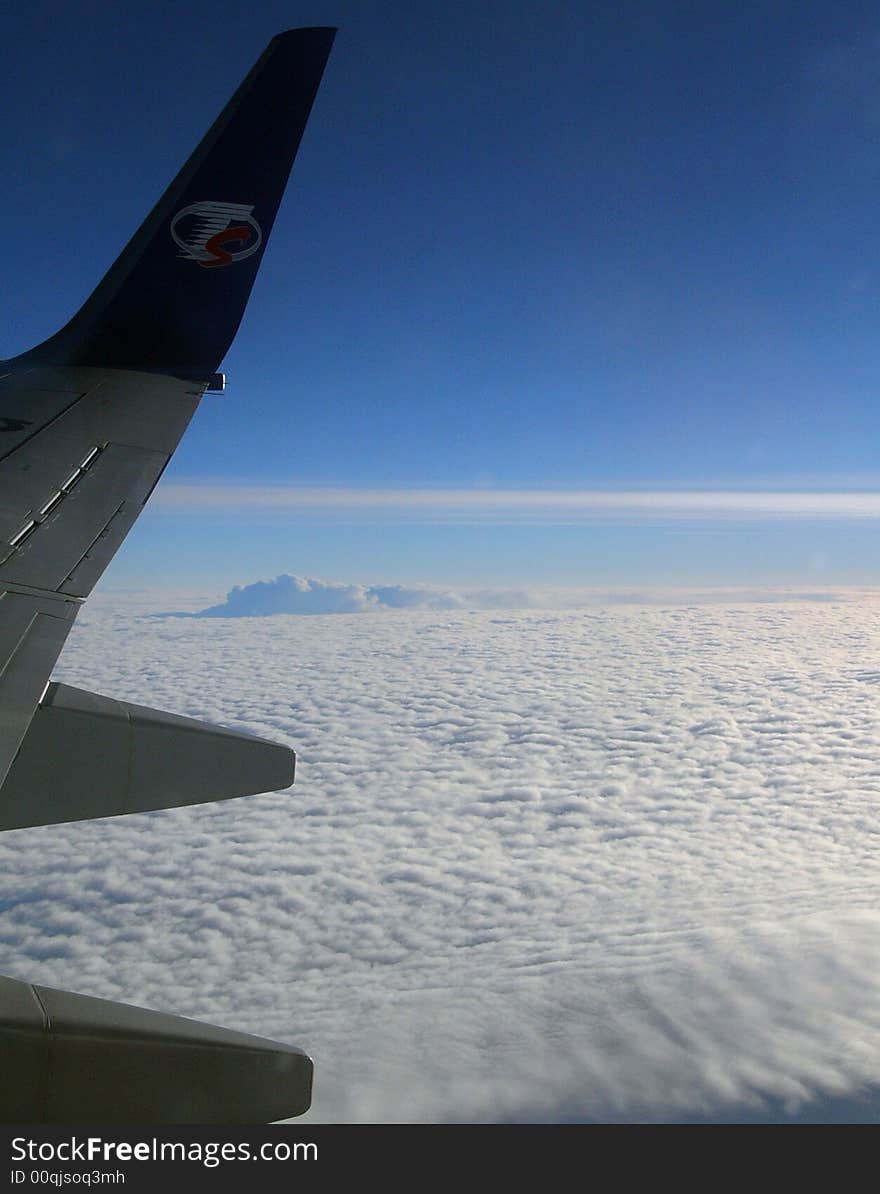 Clouds section and plane from flying aircraft. above the clouds.