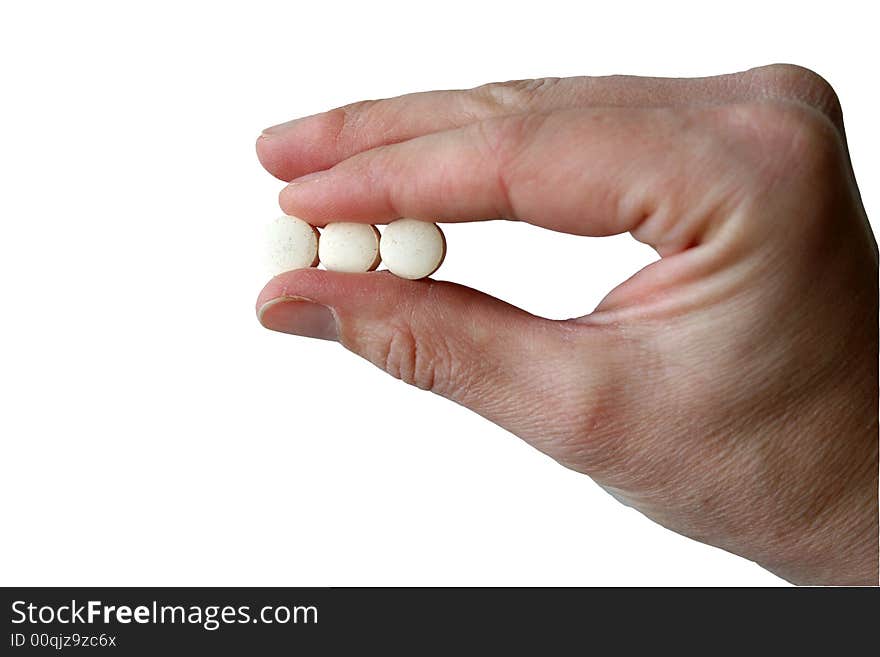 Three pills are being held between thumb and forefinger signifying dosing, compliance, prescribing, etc. There is room to the left of the hand for text.