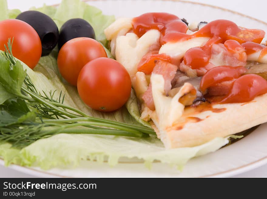 Piece of a pizza with vegetables on a plate on a white background (close up)