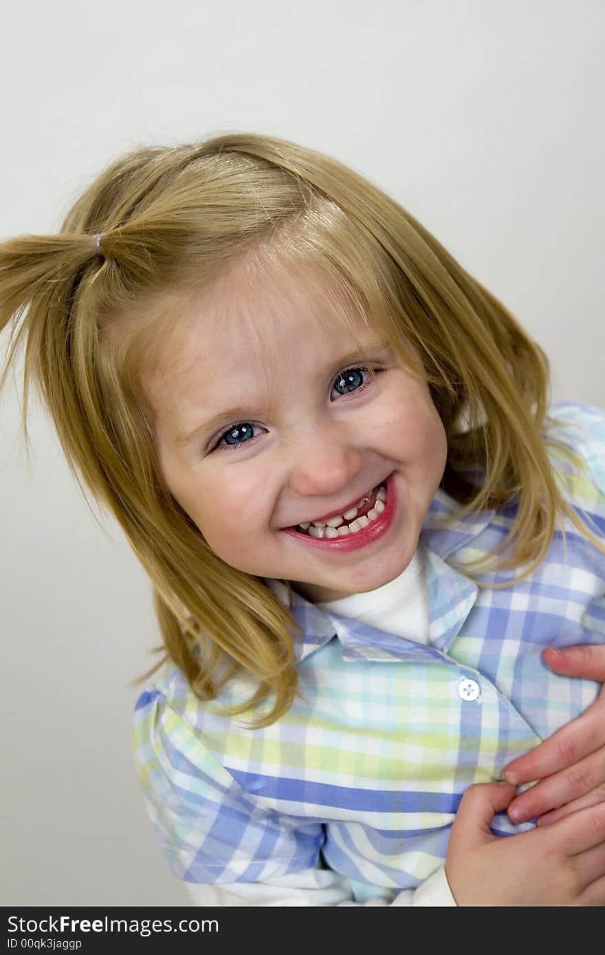 Happy, smiling two year old girl with big blue eyes and blond straight hair. Happy, smiling two year old girl with big blue eyes and blond straight hair