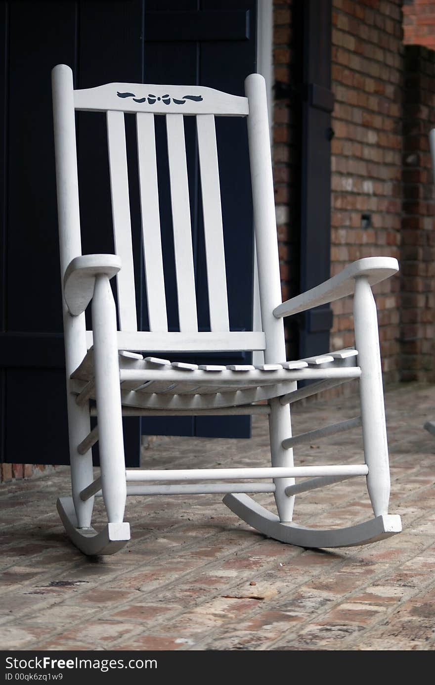 White rocking chair with a small little bow on the seatback to add a soft touch. White rocking chair with a small little bow on the seatback to add a soft touch.