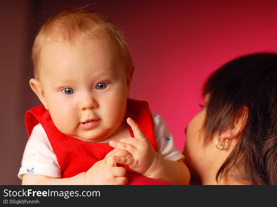 A girl with her mammy holding her