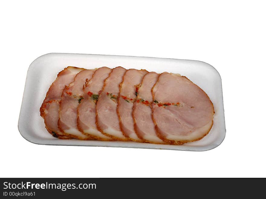 Slices of a ham with spices isolated on a white background