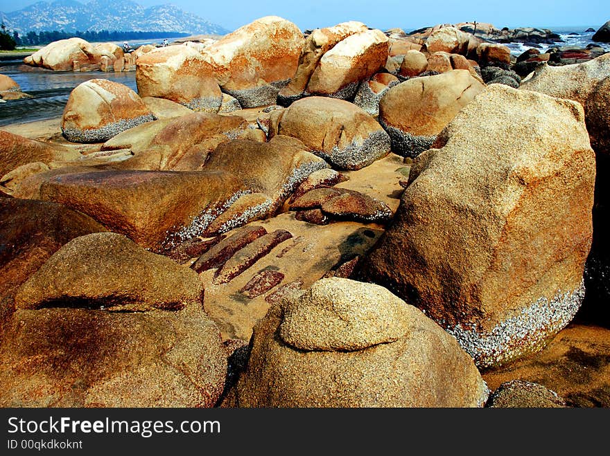 Brown and yellow boulders by the south china seaside. Brown and yellow boulders by the south china seaside