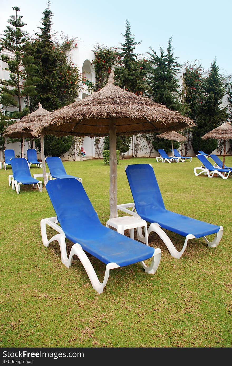 Lots of blue deckchairs beside a hotel in Tunisia.