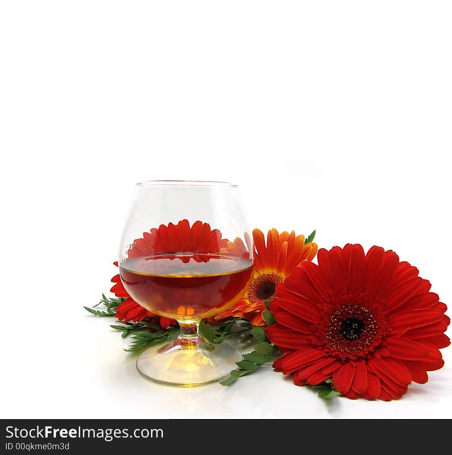 Congratulatory card with cognac and red flowers on a white background