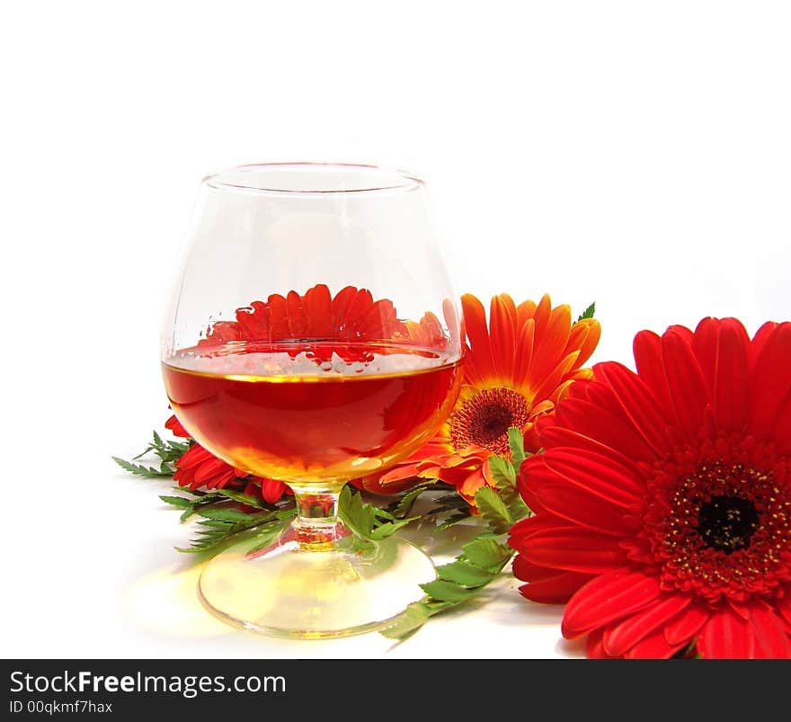 Congratulatory card with cognac and red flowers on a white background