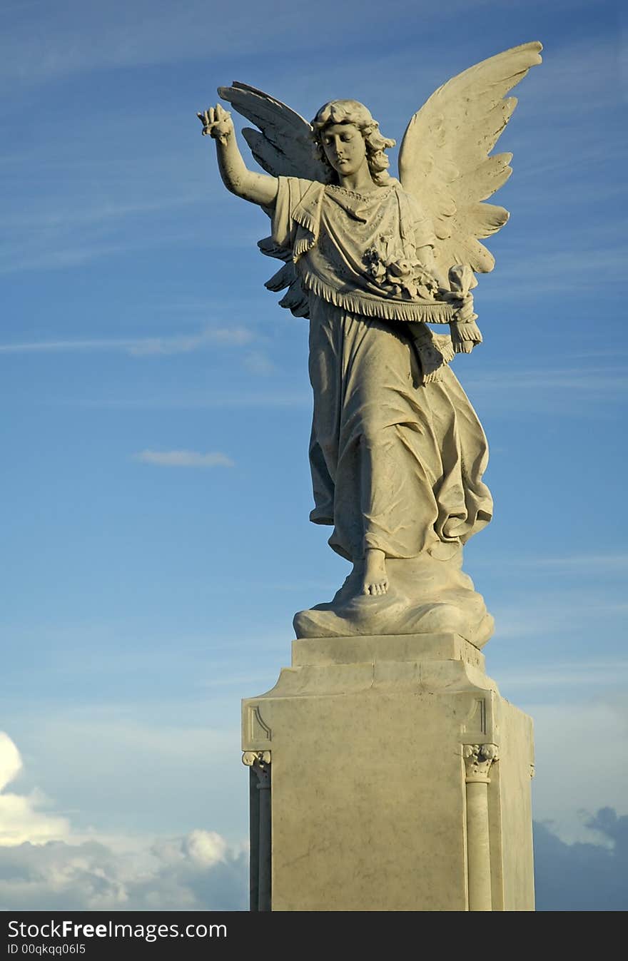 Grey angel sculpture on cloudy nice sky. Grey angel sculpture on cloudy nice sky