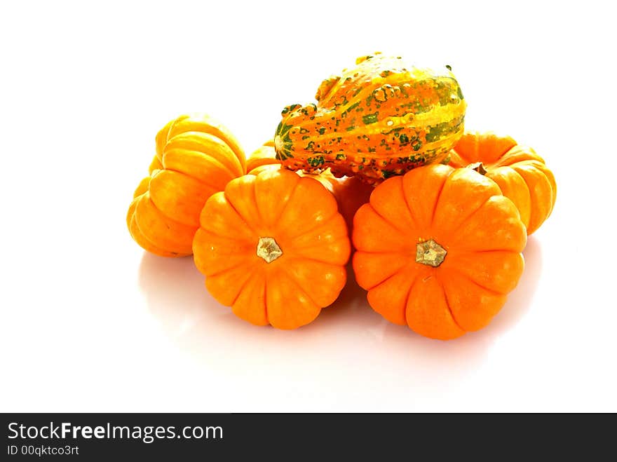 Orange pumpkins with a textured orange gourd on top. Orange pumpkins with a textured orange gourd on top.