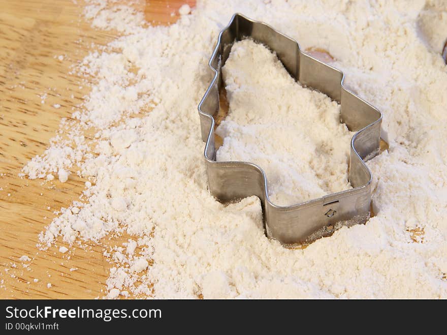 Holiday shaped cookie cutters in flour. Holiday shaped cookie cutters in flour