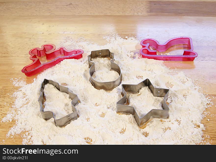 Holiday shaped cookie cutters in flour. Holiday shaped cookie cutters in flour