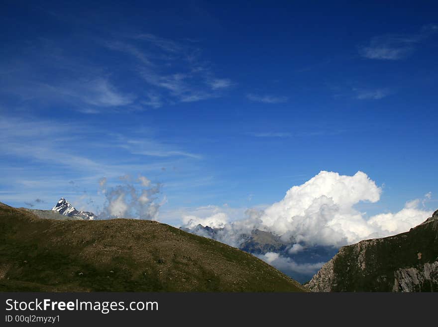 Monviso. The Stone King,  appears far in a cloudy sky