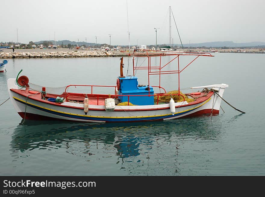 Colorful fishing boat anchored in ocean in greece. Colorful fishing boat anchored in ocean in greece