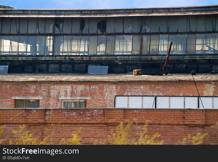 Old factory behind the brick wall.