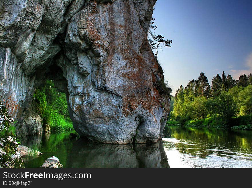 Rock similar to the horse drinking water, The Ural mountains, in Russia, park Olen'i the river