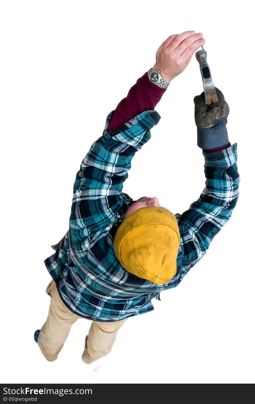 A man getting ready to pound a nail. A man getting ready to pound a nail