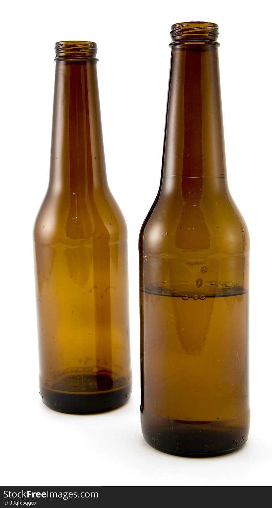 Two Beer Bottles, One Half Empty Isolated on White Background.