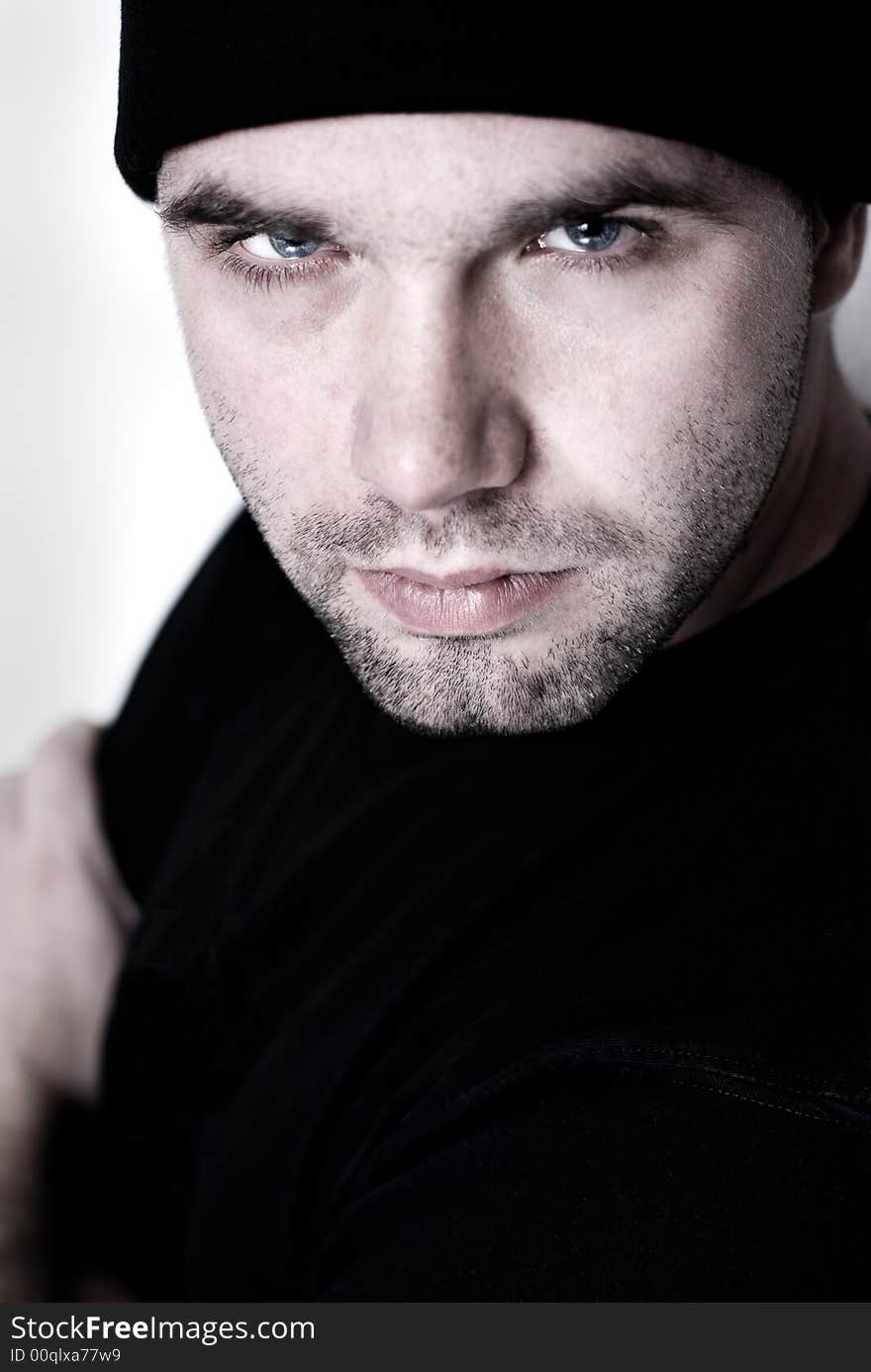 Portrait of young man wearing beanie - selective focus on the model's right eye. Portrait of young man wearing beanie - selective focus on the model's right eye.