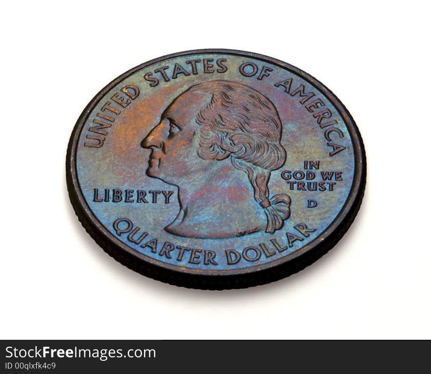 The Obverse Side of an American Quarter with saturated gold-magenta-blue patina. This is a close-up angled macro with deep depth of focus, coin has a small relief shadow, but also a clean clipping path to isolate the coin from the background. The phrases 'United States of America', Liberty, 'In God We Trust' and 'Quarter Dollar' are easily read. Minted in Denver. The Obverse Side of an American Quarter with saturated gold-magenta-blue patina. This is a close-up angled macro with deep depth of focus, coin has a small relief shadow, but also a clean clipping path to isolate the coin from the background. The phrases 'United States of America', Liberty, 'In God We Trust' and 'Quarter Dollar' are easily read. Minted in Denver.