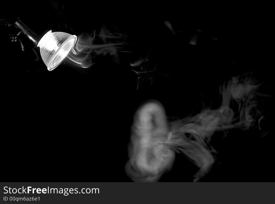 Smoke in light of a lamp. Monochrome