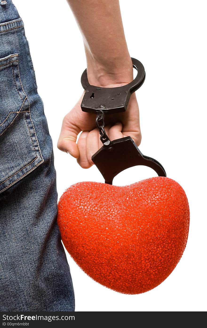 Isolated man hand with handcuffs and heart and leg in the jeans