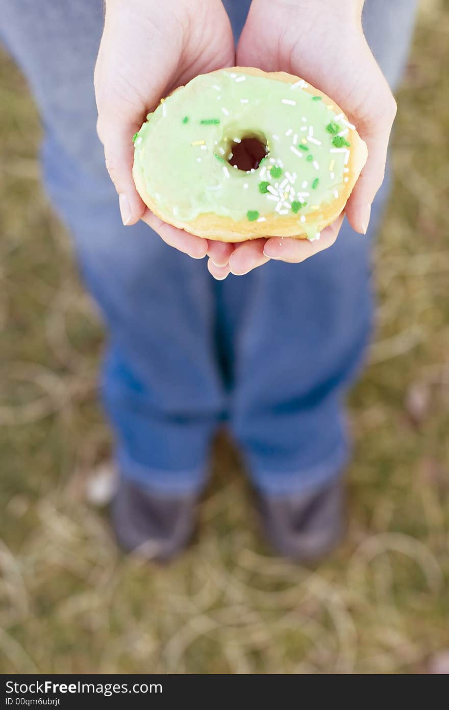 High-angle view of woman holding donut in hands