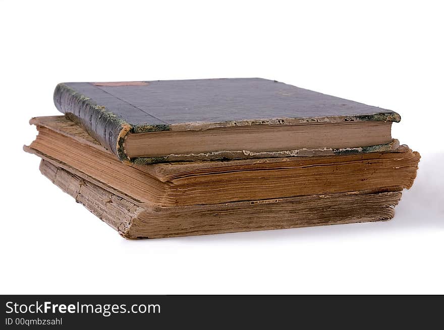 Pile from three ancient books. Isolated on white background.