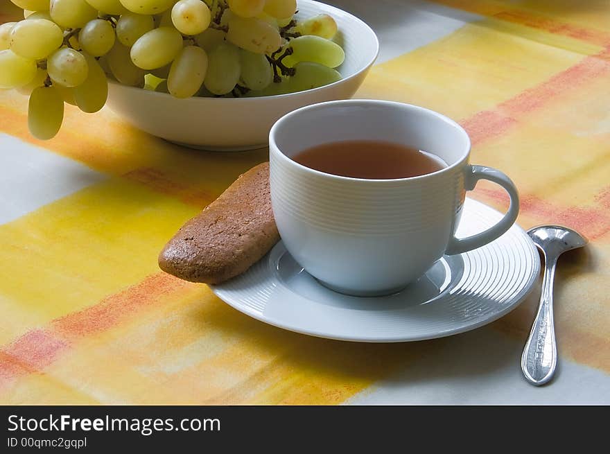 Cup Of Tea With A Biscuit And Grapes