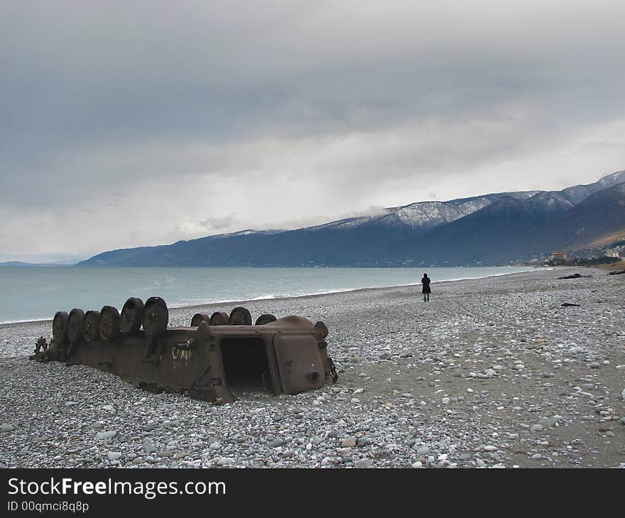 Lonely girl walking away from war machine. Lonely girl walking away from war machine