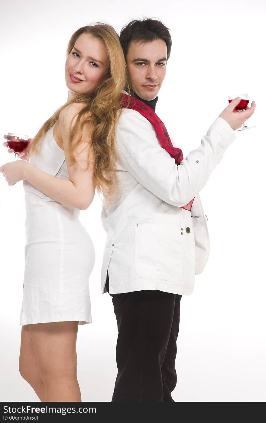 The man and the woman in white clothes with red wine. The man and the woman in white clothes with red wine