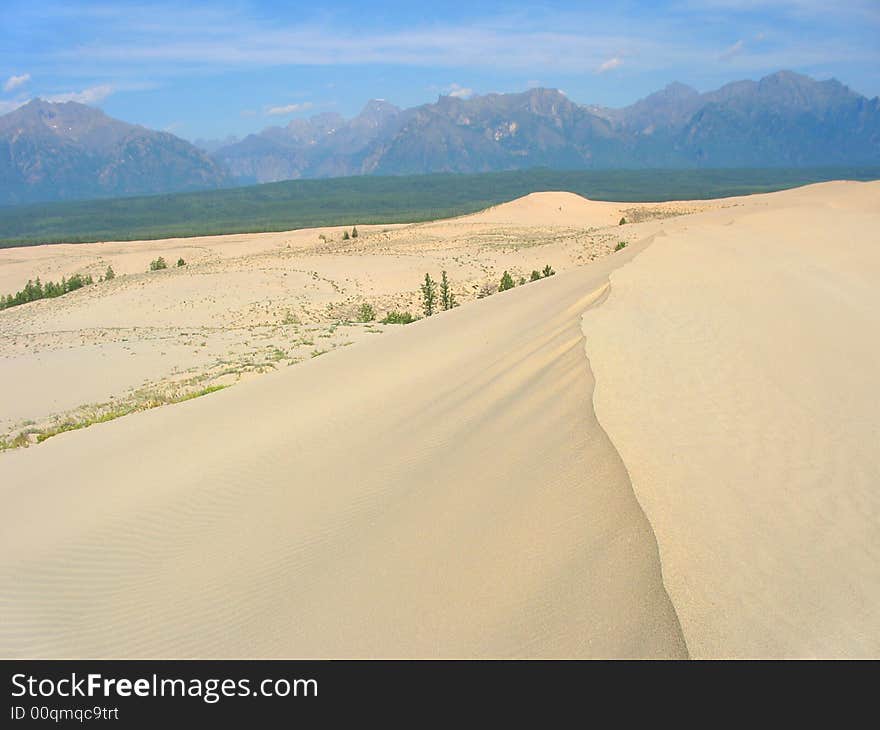 Chara desert. sand dunes and far mountains. Chara desert. sand dunes and far mountains