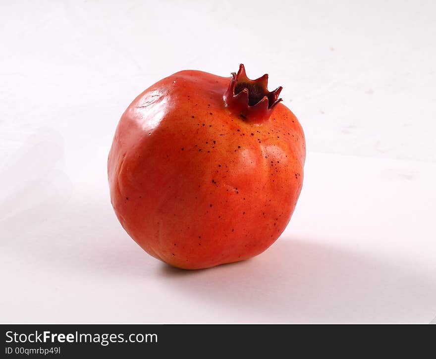 Whole pomegranate isolated on white background