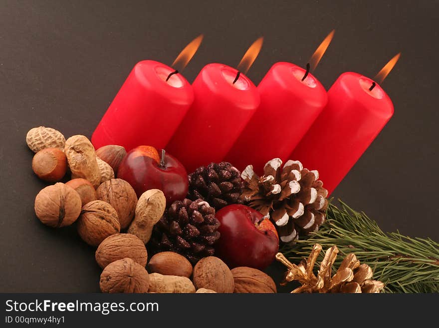 Advent red candels and still life on a black background.