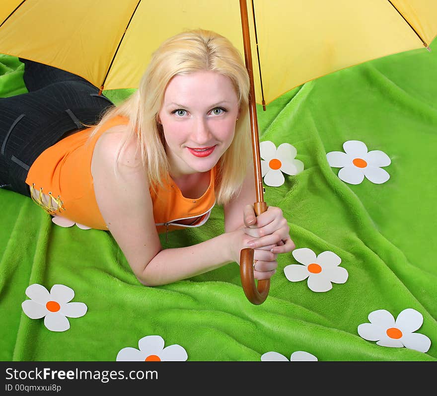 Blond girl is lying on artificial grass. Blond girl is lying on artificial grass