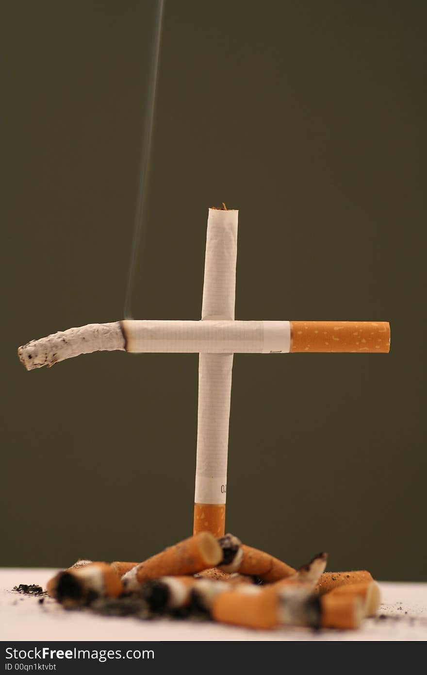 Zigarettes cross ,anti smoking on a drak green background. Zigarettes cross ,anti smoking on a drak green background.