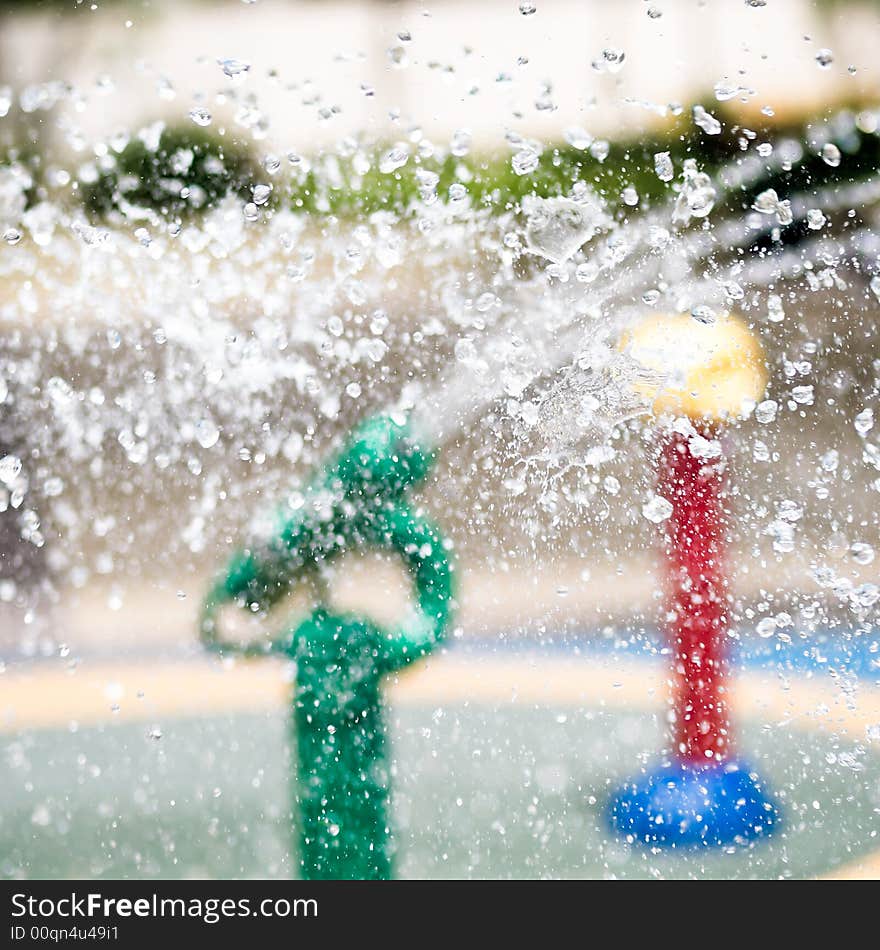 Water droplets colliding in mid air in a children's water playground. Water droplets colliding in mid air in a children's water playground