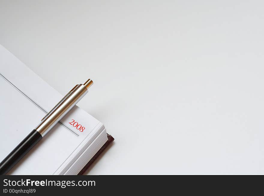 Notebook and ballpoint on the table