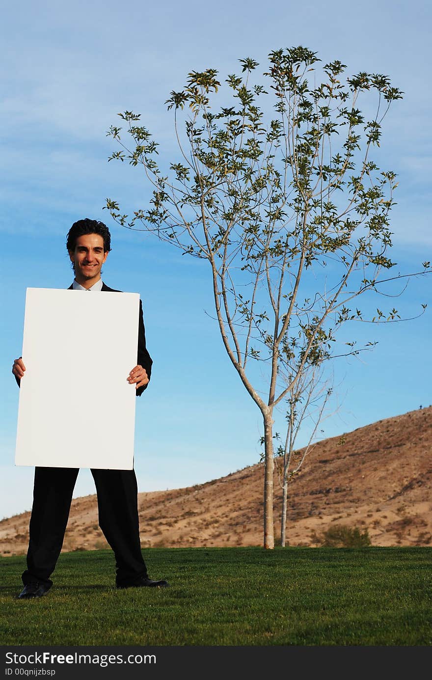 Businessman holding blank board