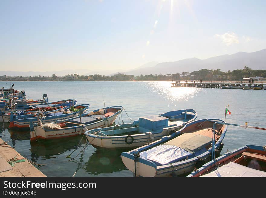 Colorful Sicilian boats on the dock in the port of Mondello, near Palermo. Coast line and beach. Sicily - Italy. Colorful Sicilian boats on the dock in the port of Mondello, near Palermo. Coast line and beach. Sicily - Italy